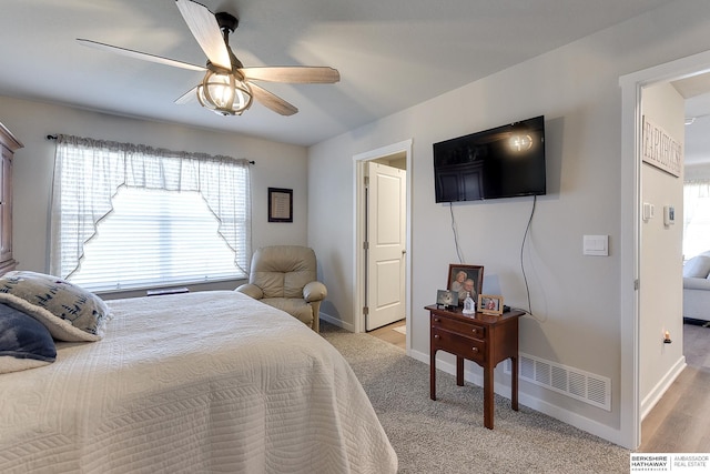 bedroom with baseboards, a ceiling fan, and visible vents