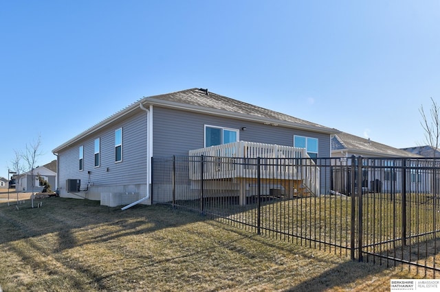 exterior space with a yard, fence, a deck, and central AC unit