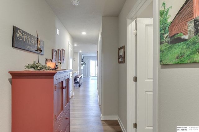 hallway with baseboards, recessed lighting, and dark wood-style floors