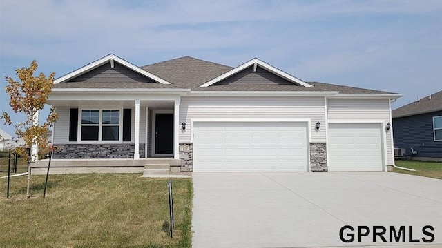 6308 Harvest Dr, Papillion, NE 68157 - craftsman-style house featuring concrete driveway, a front yard, stone siding, and an attached garage