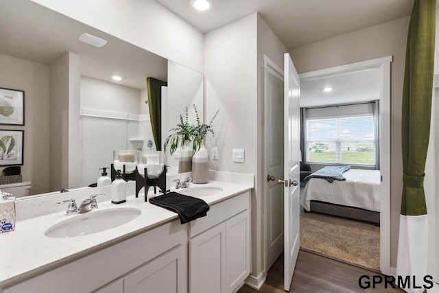 6308 Harvest Dr, Papillion, NE 68157 - bathroom featuring recessed lighting, double vanity, a sink, and wood finished floors