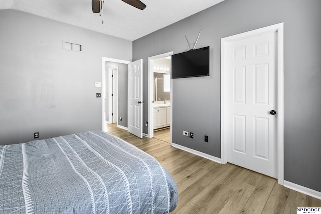 bedroom featuring light wood-type flooring, baseboards, ensuite bathroom, and a ceiling fan