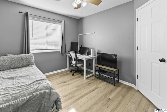 bedroom featuring wood finished floors, baseboards, a desk, and ceiling fan