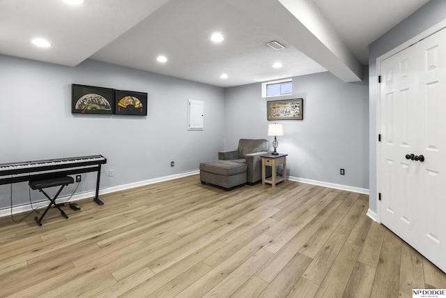 living area with baseboards, recessed lighting, and light wood finished floors