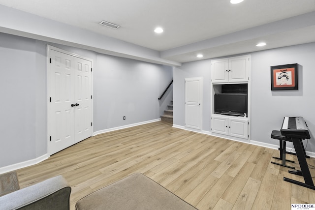 living area featuring recessed lighting, light wood-style floors, stairs, and baseboards
