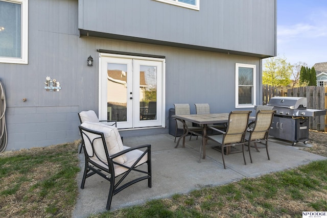 view of patio featuring area for grilling, fence, french doors, and outdoor dining area