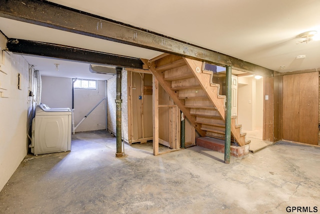 basement featuring stairway and washer / dryer