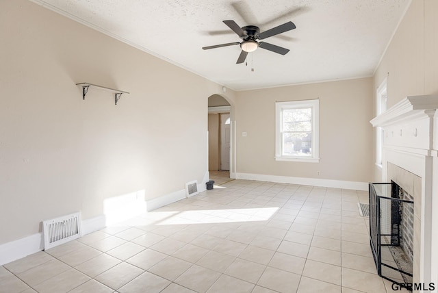 unfurnished living room featuring arched walkways, visible vents, a ceiling fan, and ornamental molding