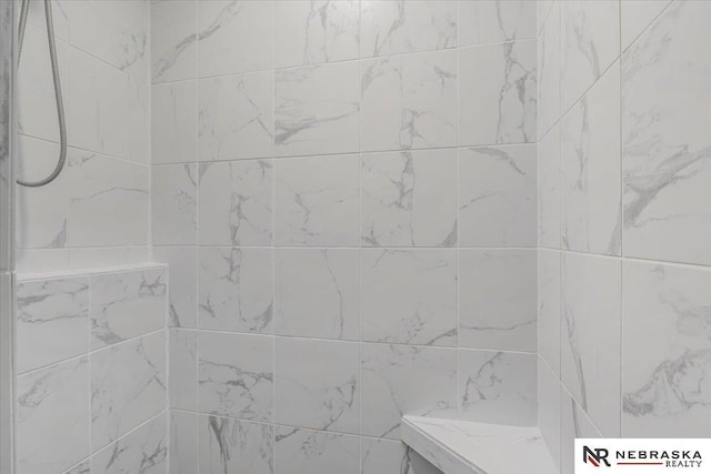 bathroom with tiled shower