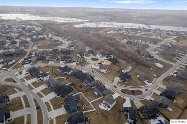drone / aerial view with a residential view and a water view