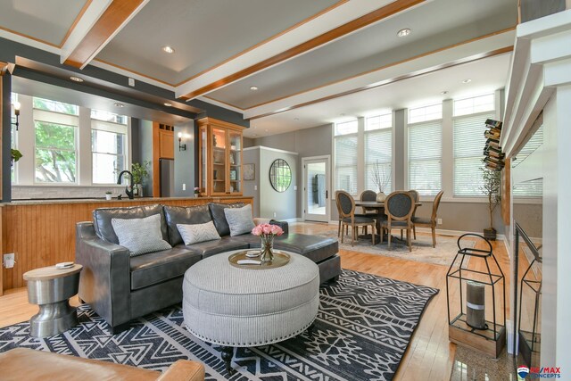living room with baseboards, light wood-style floors, beamed ceiling, and recessed lighting