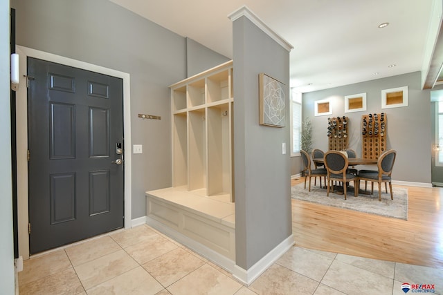 mudroom with baseboards, recessed lighting, and light tile patterned flooring