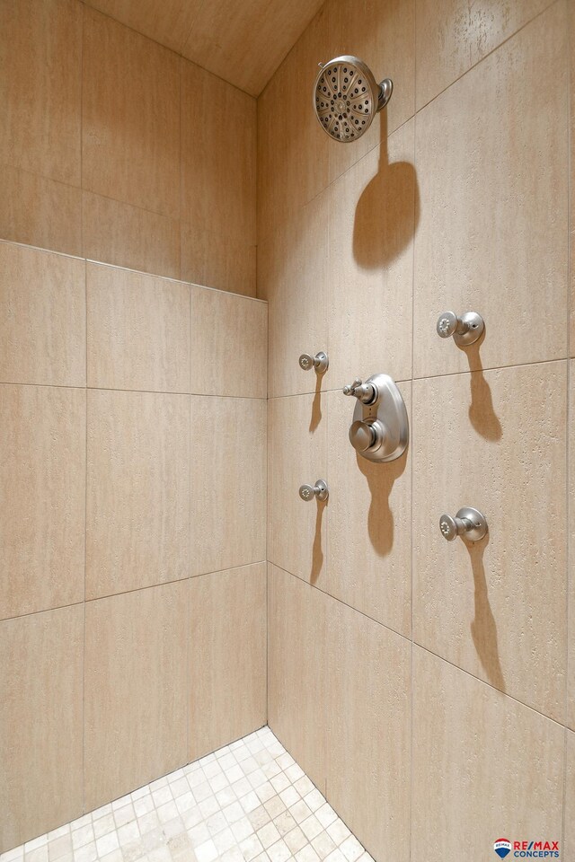 full bath with a tile shower