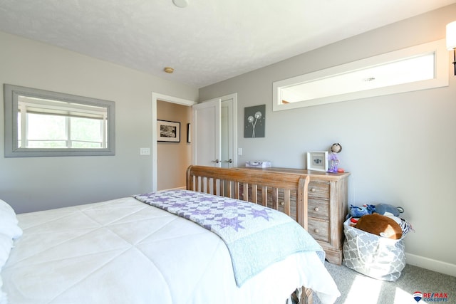 carpeted bedroom with baseboards