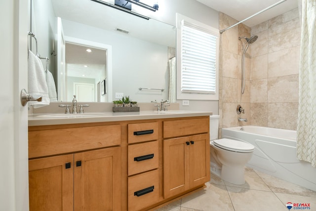 bathroom with tile patterned floors, shower / bath combo, visible vents, and a sink