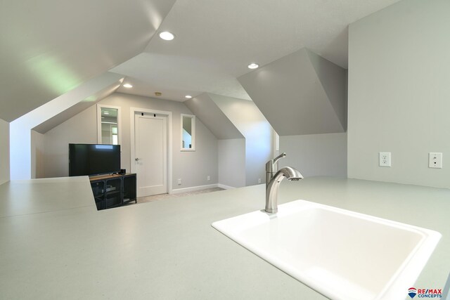 bonus room with vaulted ceiling, a sink, and recessed lighting