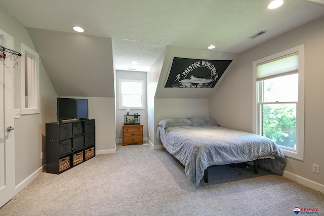 carpeted bedroom featuring lofted ceiling, baseboards, visible vents, and recessed lighting