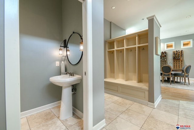 bathroom with baseboards, tile patterned flooring, recessed lighting, and a sink