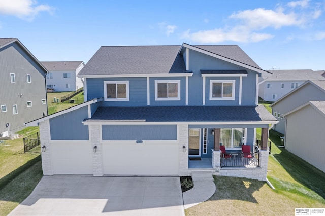 6315 N Hws Cleveland Blvd, Omaha, NE 68116 - view of front of house with concrete driveway, a front lawn, a porch, and a shingled roof