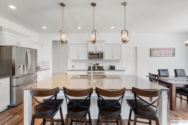 6315 N Hws Cleveland Blvd, Omaha, NE 68116 - kitchen featuring stainless steel appliances, a sink, tasteful backsplash, and dark wood finished floors