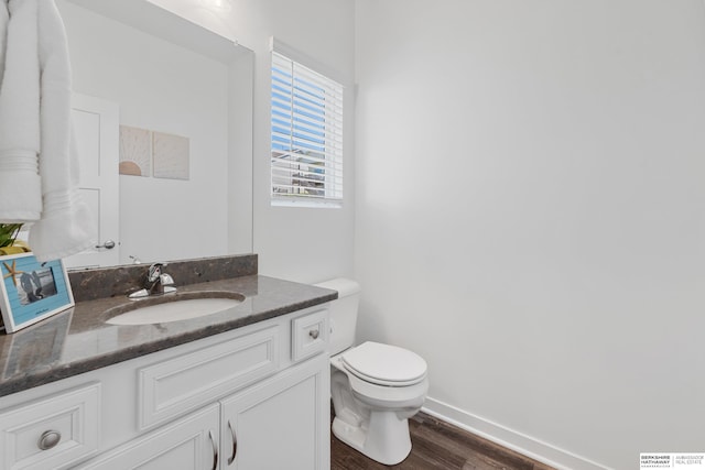 6315 N Hws Cleveland Blvd, Omaha, NE 68116 - bathroom with baseboards, wood finished floors, vanity, and toilet