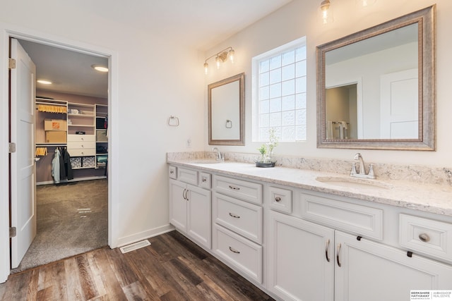 6315 N Hws Cleveland Blvd, Omaha, NE 68116 - bathroom with a walk in closet, wood finished floors, a sink, and double vanity