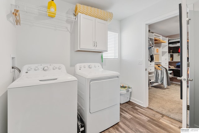 6315 N Hws Cleveland Blvd, Omaha, NE 68116 - laundry area featuring cabinet space, light wood-type flooring, and washing machine and clothes dryer