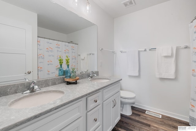 6315 N Hws Cleveland Blvd, Omaha, NE 68116 - bathroom featuring toilet, a sink, and visible vents