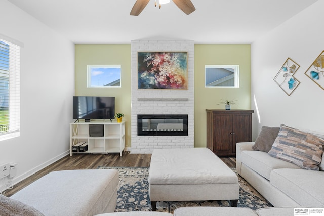 6315 N Hws Cleveland Blvd, Omaha, NE 68116 - living area featuring a large fireplace, a ceiling fan, wood finished floors, and baseboards