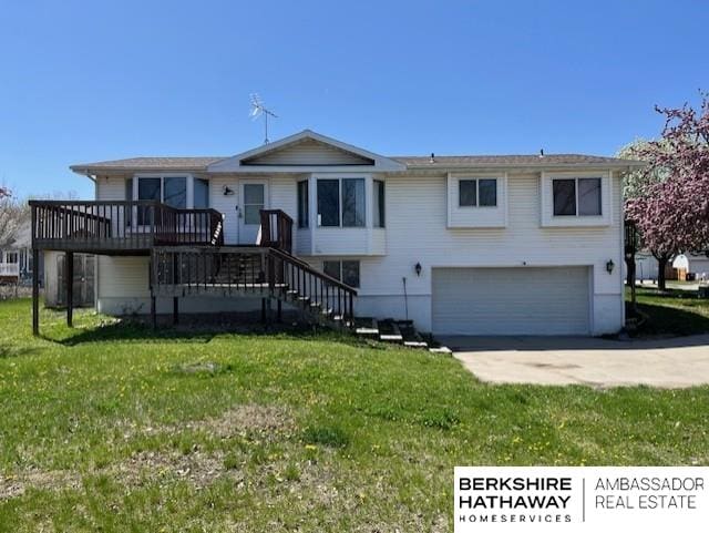 2331 W C Ct, Lincoln, NE 68522 - view of front of property featuring a wooden deck, concrete driveway, a front yard, and a garage