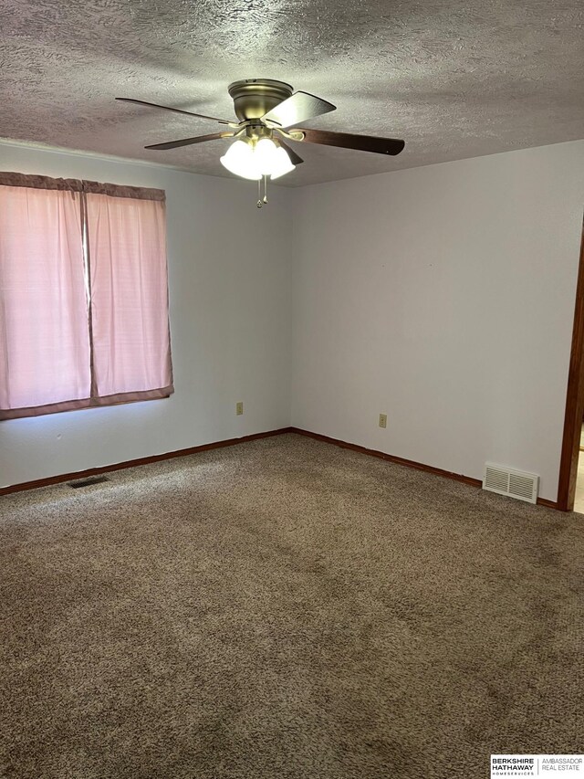 2331 W C Ct, Lincoln, NE 68522 - carpeted empty room featuring a textured ceiling, visible vents, a ceiling fan, and baseboards
