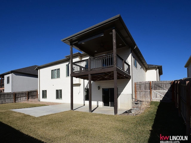 back of house with a patio, a fenced backyard, a ceiling fan, and a yard