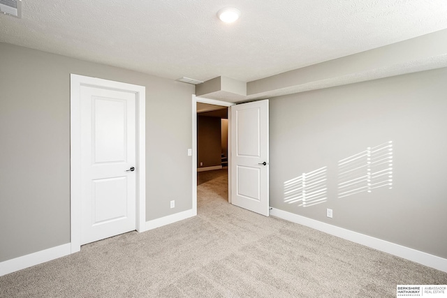 below grade area featuring baseboards, carpet flooring, and visible vents