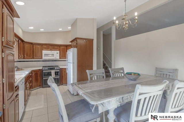 dining area with light tile patterned flooring, stairs, recessed lighting, and an inviting chandelier