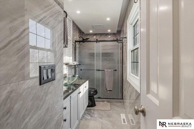 full bath featuring recessed lighting, vanity, toilet, and a stall shower