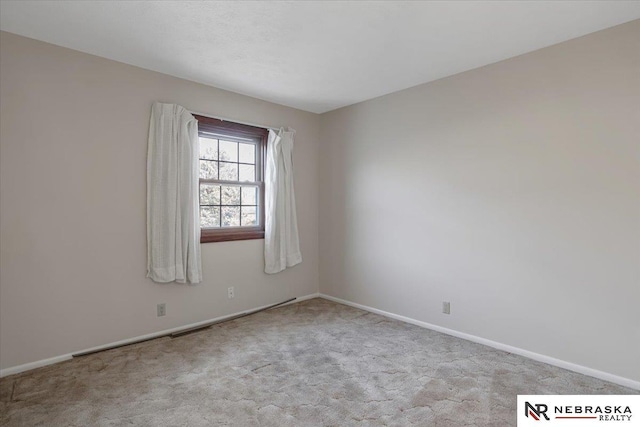 empty room with baseboards and carpet