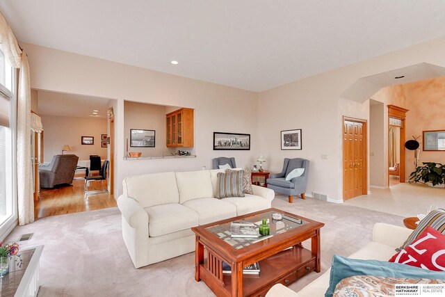 living room with light carpet and recessed lighting