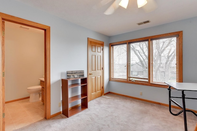 carpeted bedroom featuring baseboards and connected bathroom