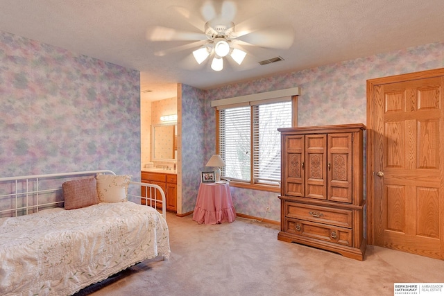 bedroom with light carpet, wallpapered walls, baseboards, and a ceiling fan