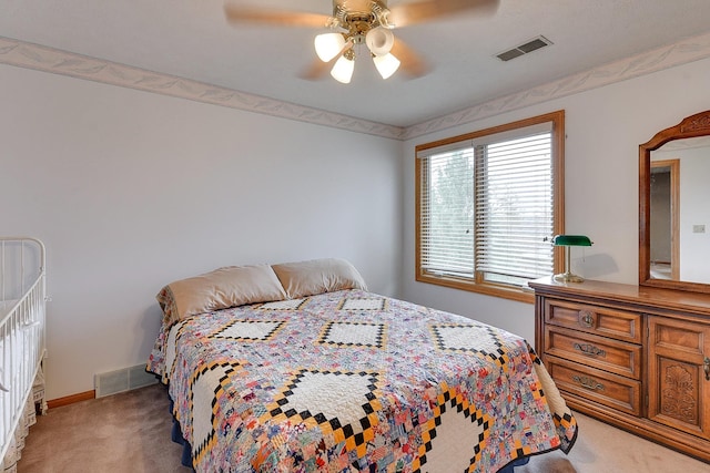 bedroom featuring light colored carpet, baseboards, and ceiling fan