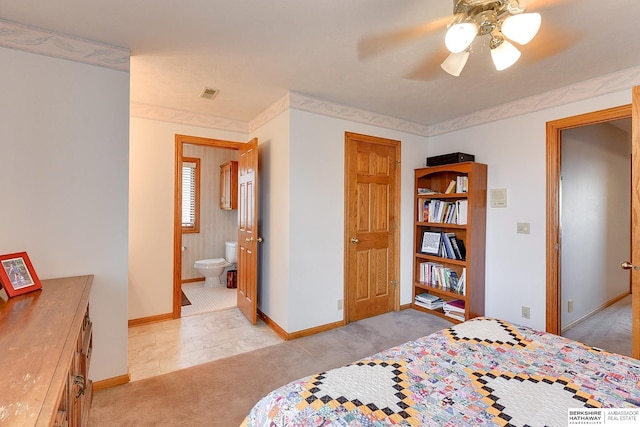 bedroom with light carpet, baseboards, a ceiling fan, and ensuite bathroom