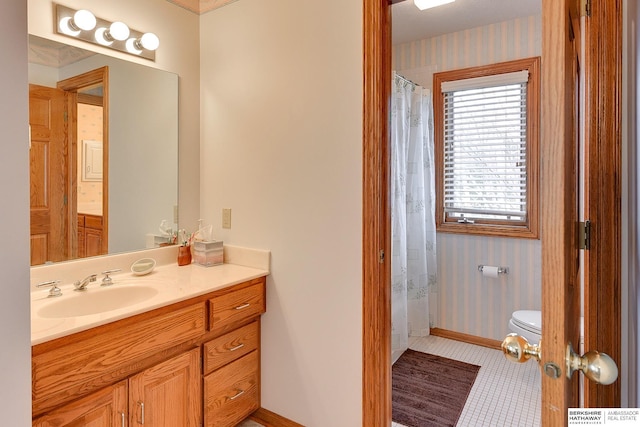 bathroom with wallpapered walls, toilet, baseboards, vanity, and tile patterned flooring
