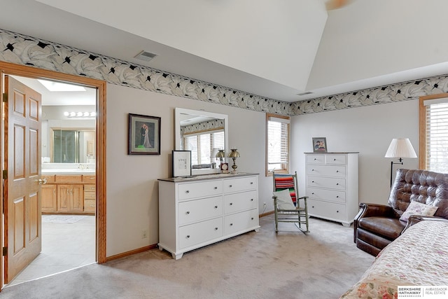 bedroom with light colored carpet, lofted ceiling, baseboards, multiple windows, and ensuite bathroom