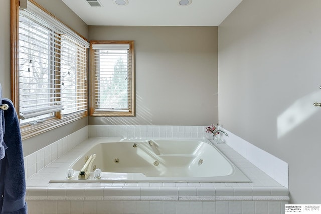 bathroom with a tub with jets