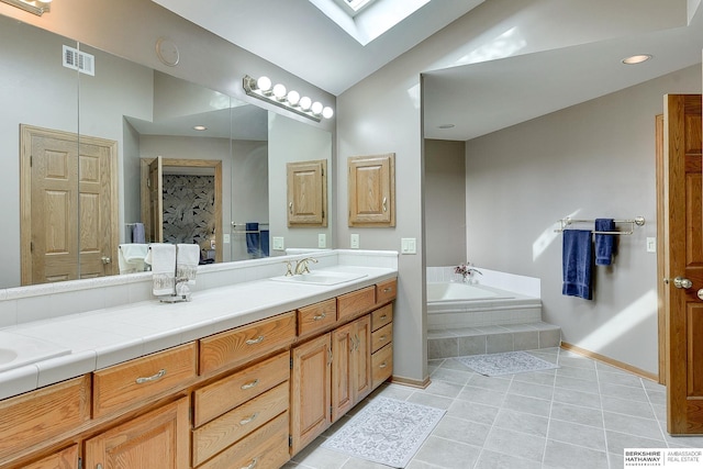 full bathroom featuring a skylight, a bath, tile patterned floors, vaulted ceiling, and baseboards