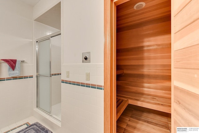 sauna / steam room featuring wainscoting