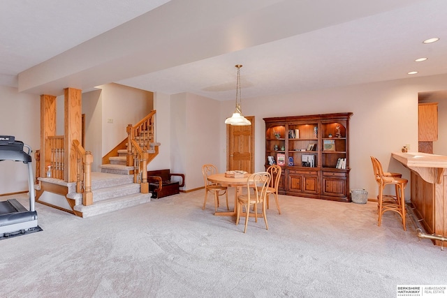 carpeted dining room featuring baseboards, stairs, and recessed lighting