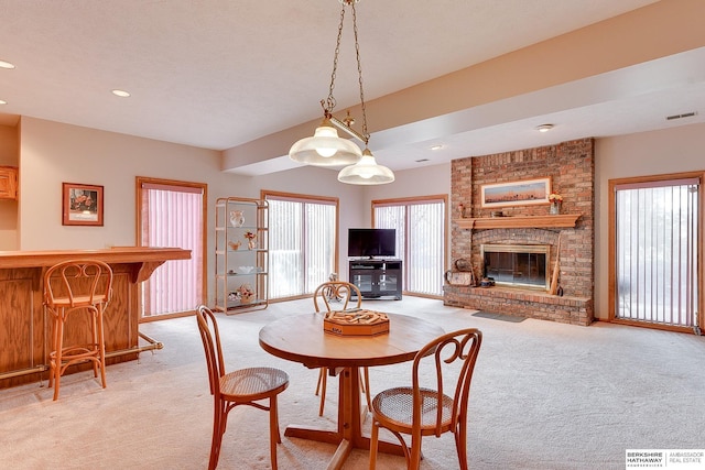 dining area with light colored carpet, a fireplace, a dry bar, recessed lighting, and baseboards