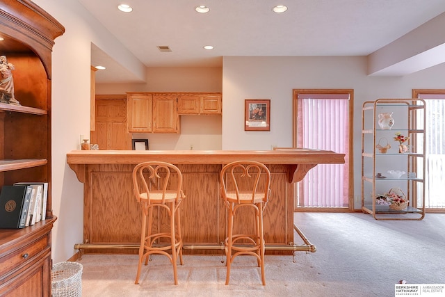indoor bar with light carpet and recessed lighting