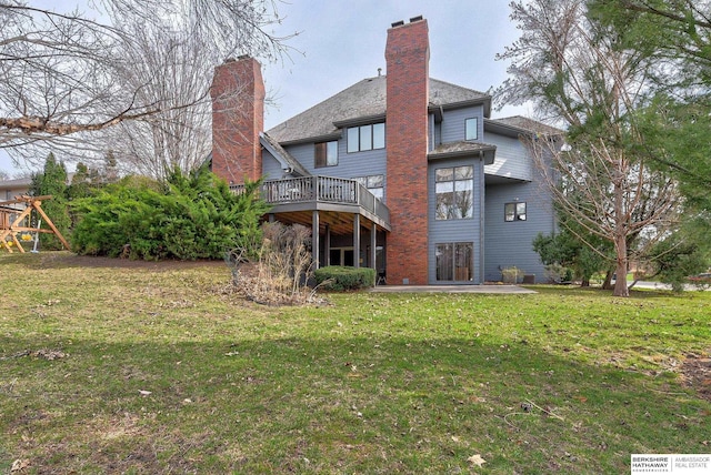back of property featuring a yard, a patio, a chimney, and a playground